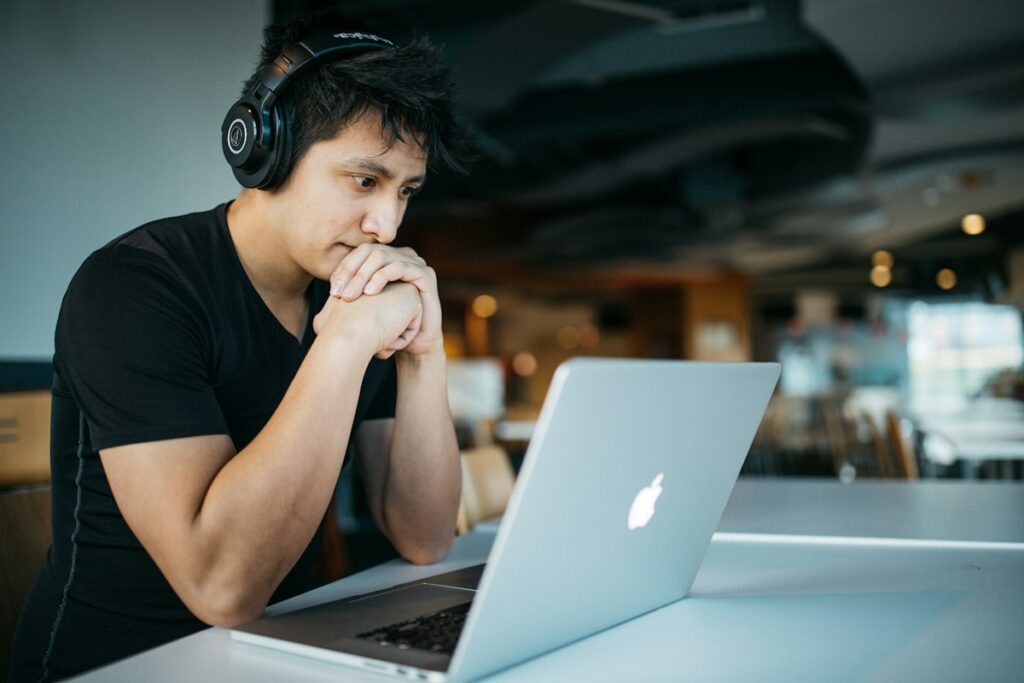 Student studying with notes and laptop